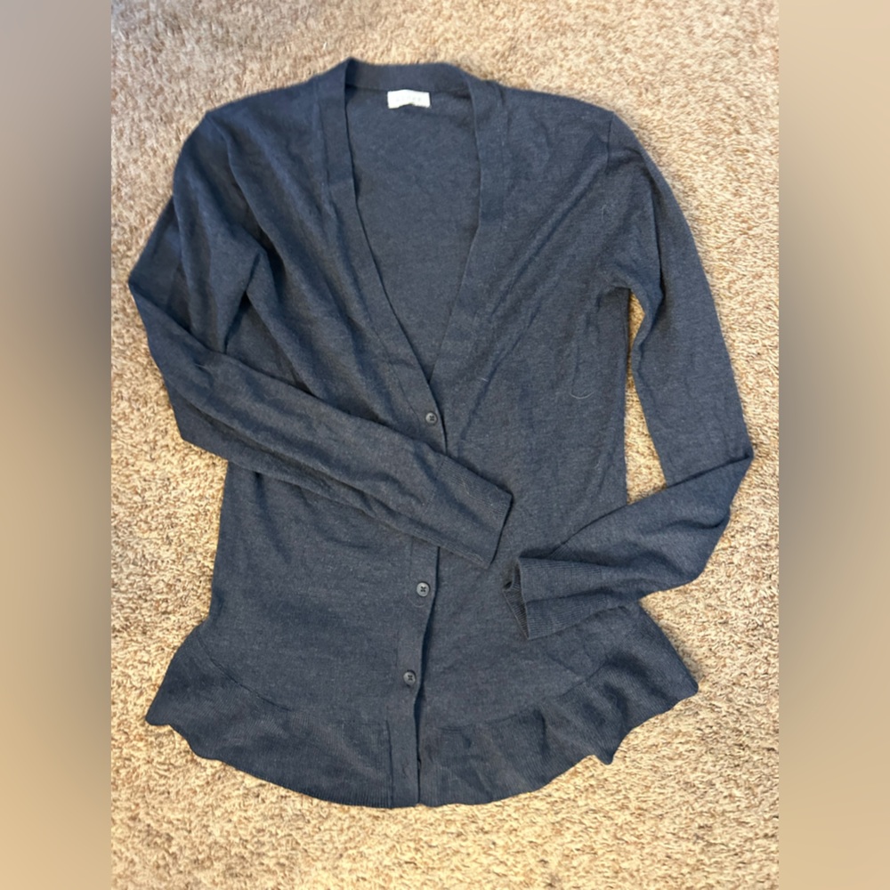 Woman’s grey sweater.